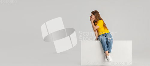 Image of Happy kid, girl isolated on white studio background. Looks happy, cheerful, sincere. Copyspace. Childhood, education, emotions concept