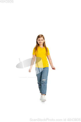 Image of Happy kid, girl isolated on white studio background. Looks happy, cheerful, sincere. Copyspace. Childhood, education, emotions concept