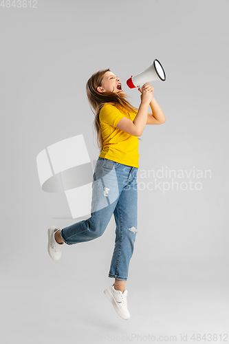 Image of Happy kid, girl isolated on white studio background. Looks happy, cheerful, sincere. Copyspace. Childhood, education, emotions concept