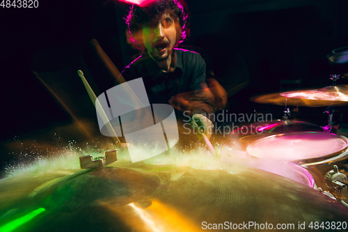 Image of Drummer\'s rehearsing on drums before rock concert. Man recording music on drumset in studio