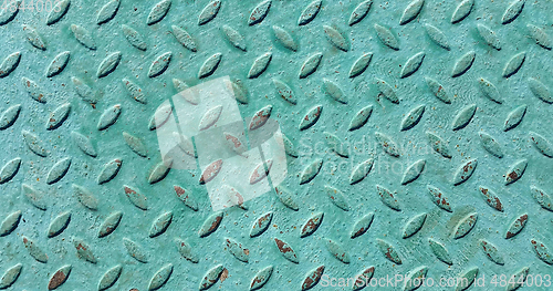 Image of Old metal diamond plate covered with green paint