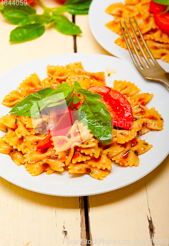 Image of Italian pasta farfalle butterfly bow-tie and tomato sauce