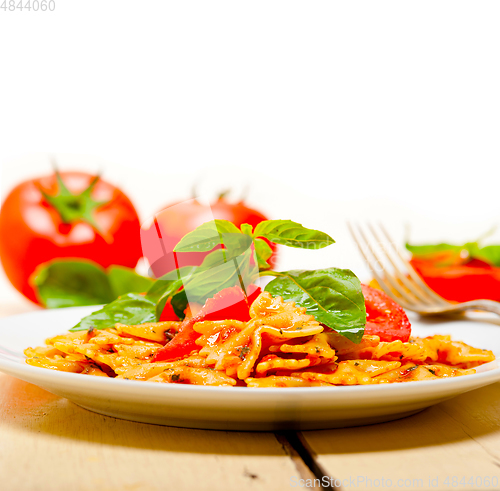 Image of Italian pasta farfalle butterfly bow-tie and tomato sauce