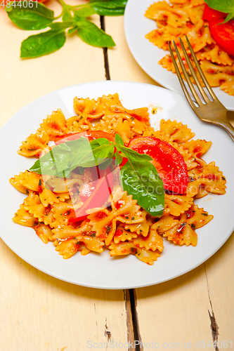 Image of Italian pasta farfalle butterfly bow-tie and tomato sauce