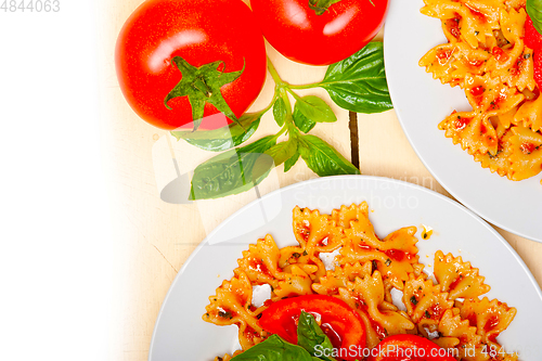 Image of Italian pasta farfalle butterfly bow-tie and tomato sauce