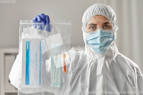 Image of doctor in protective wear with medical test sample