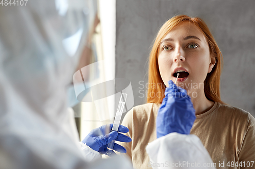 Image of doctor in protective wear making coronavirus test