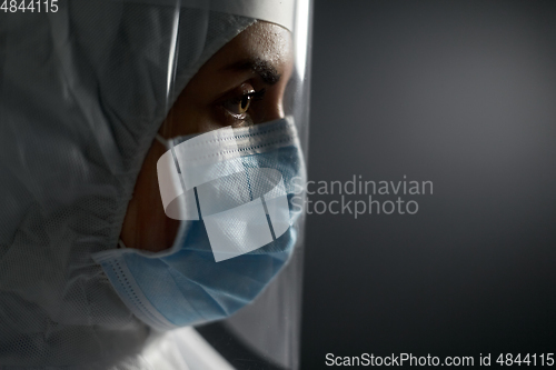 Image of doctor in protective wear, mask and face shield