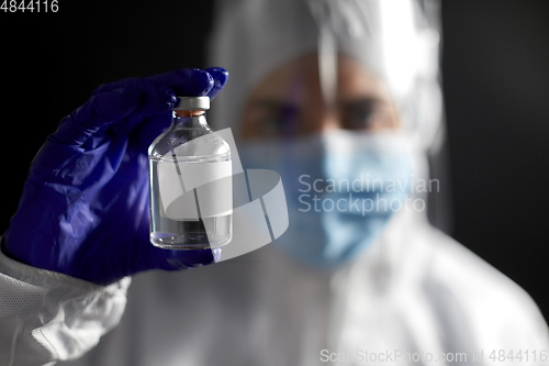 Image of close up of doctor's hand with bottle of medicine