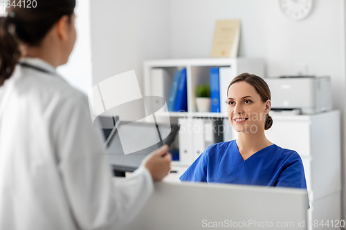 Image of doctor with tablet computer and nurse at hospital