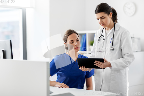 Image of doctor with tablet computer and nurse at hospital