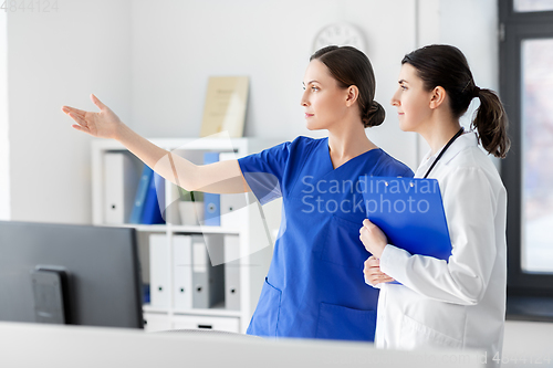 Image of nurse showing something to doctor at hospital