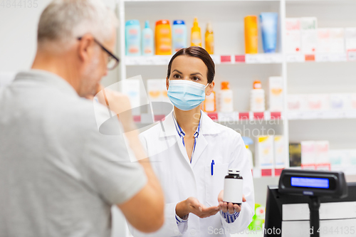 Image of apothecary in mask showing drug to man at pharmacy