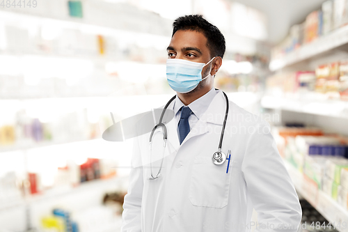 Image of indian male doctor in medical mask at pharmacy