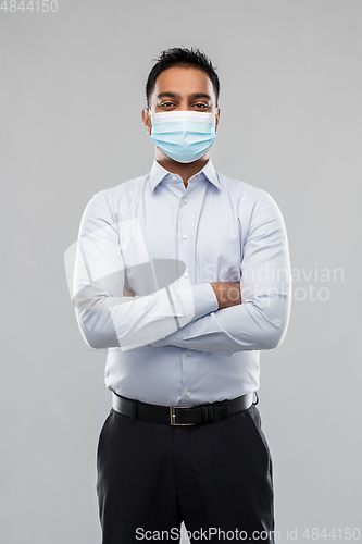 Image of indian businessman in mask over grey background