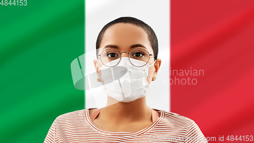 Image of african american woman in mask over flag of italy