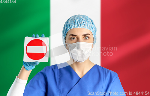 Image of italian doctor or nurse in mask showing stop sign