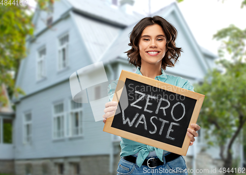 Image of happy woman with chalkboard with zero waste words