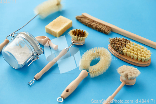 Image of cleaning brushes and soda powder with scoop in jar