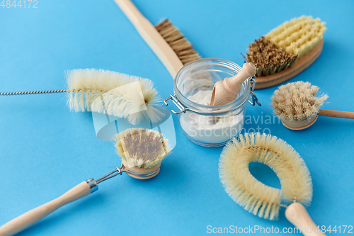 Image of cleaning brushes and soda powder with scoop in jar