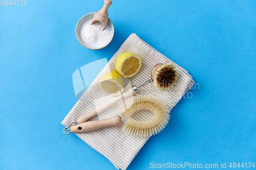 Image of cleaning brushes, lemon and washing soda on cloth