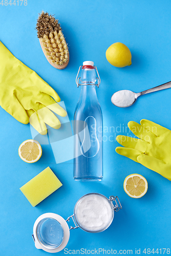 Image of vinegar, lemons, washing soda, gloves and brush