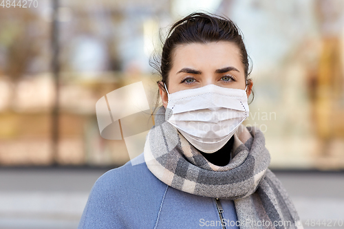 Image of young woman wearing protective medical mask