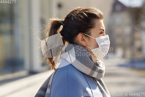 Image of young woman wearing protective medical mask