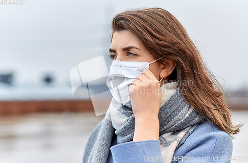 Image of young woman wearing protective medical mask