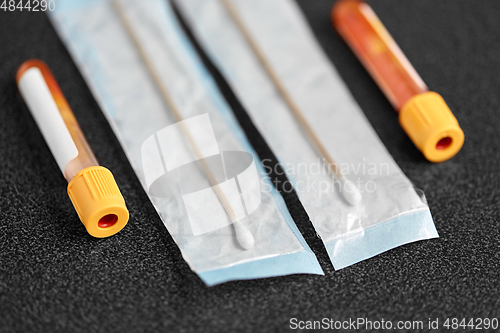 Image of test tubes with blood plasma and cotton swabs