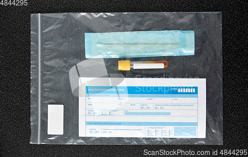 Image of beaker with test, cotton swab and medical report