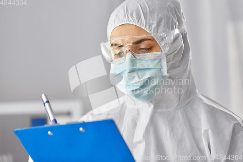 Image of doctor in medical mask and goggles with clipboard