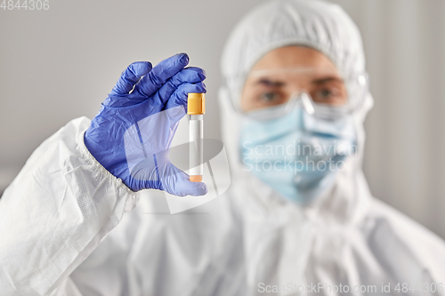 Image of scientist in protective mask with test tube