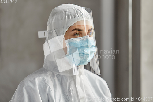 Image of doctor in protective wear, mask and face shield