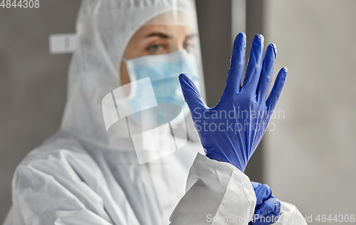 Image of doctor in protective wear, mask and face shield