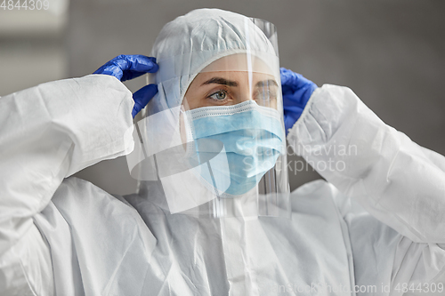 Image of doctor in protective wear, mask and face shield