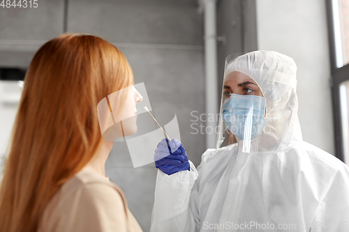 Image of doctor in protective wear making coronavirus test