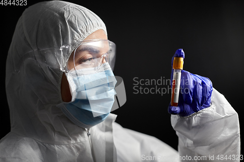 Image of scientist in protective mask with test tube