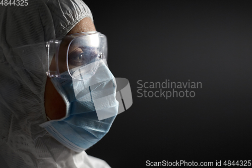 Image of doctor in protective wear, face mask and goggles