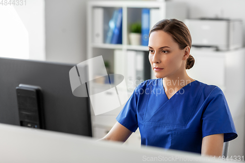 Image of doctor or nurse with computer working at hospital