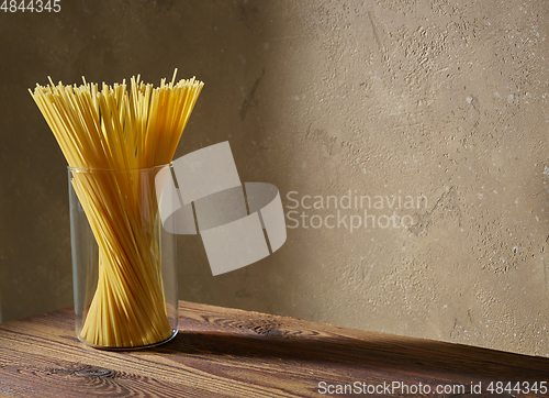 Image of spaghetti pasta on brown wooden shelf