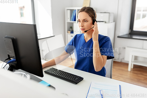 Image of doctor with headset and computer at hospital