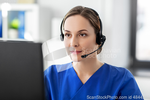 Image of doctor with headset and computer at hospital