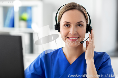 Image of doctor with headset and computer at hospital