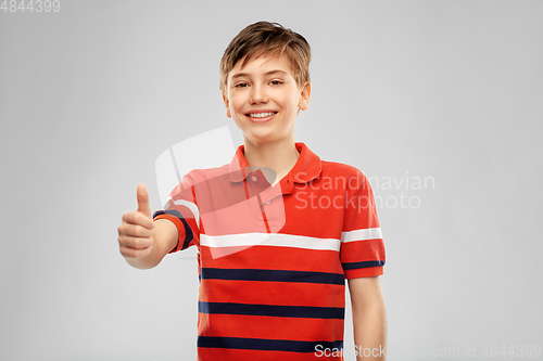 Image of happy boy in red polo t-shirt showing thumbs up