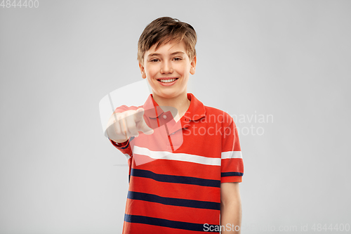 Image of portrait of smiling boy pointing finger to camera