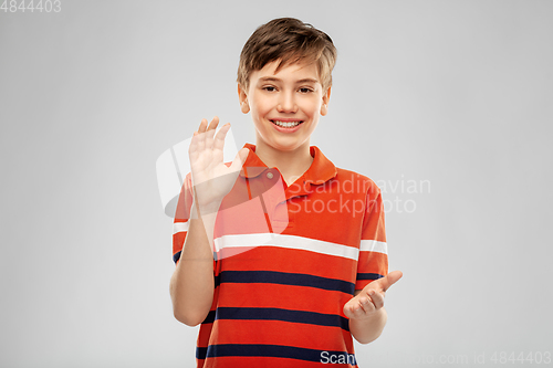 Image of portrait of happy smiling boy applauding