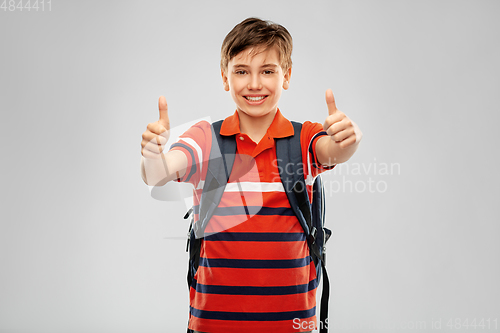 Image of happy student boy with backpack showing thumbs up