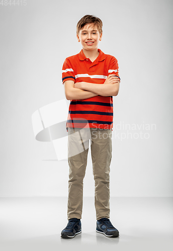 Image of portrait of happy smiling boy in red polo t-shirt