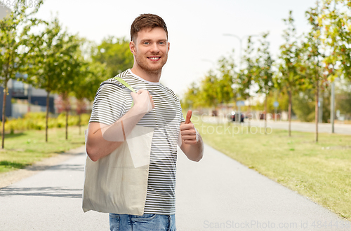 Image of man with reusable canvas bag for food shopping